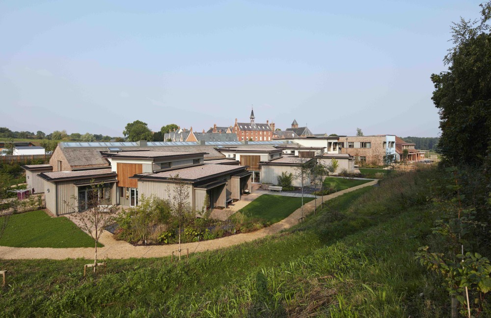 An overview of the site of the hospice, settled in the landscape