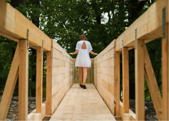 girl in a white dress walking down walkway project