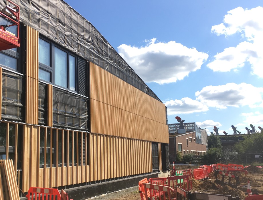 site photo of school progressing with bedzed in the background